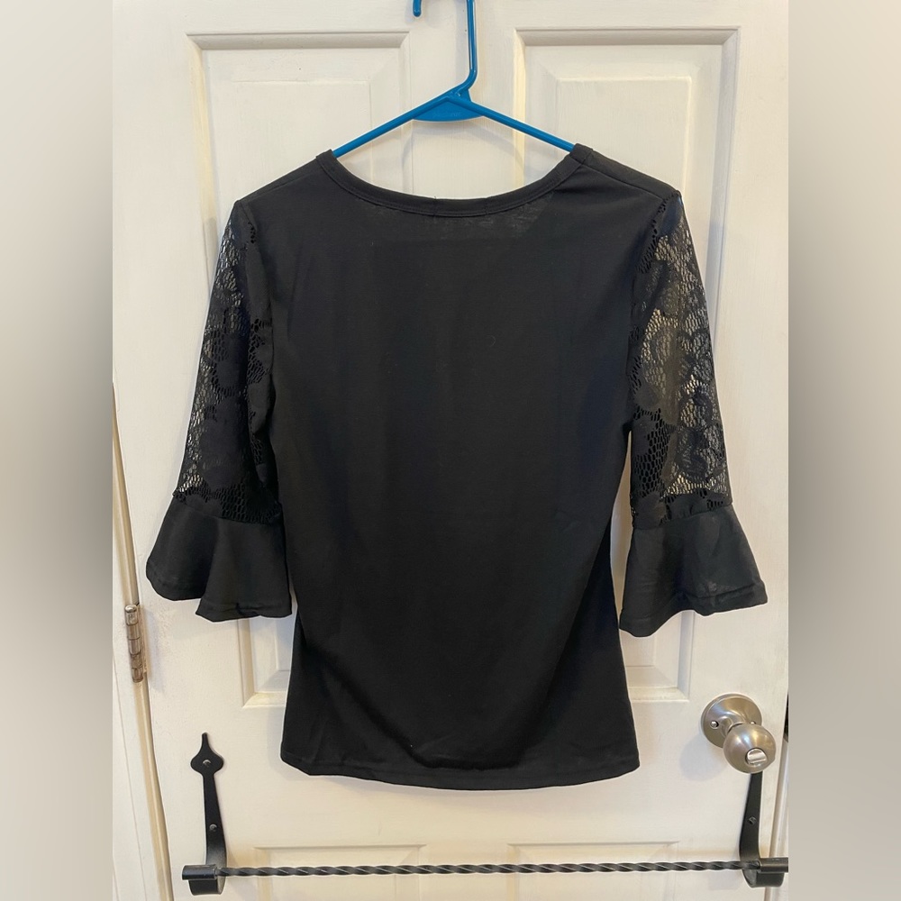 Medium Easther black 2/3 sleeve shirt. Sleeves have floral designs